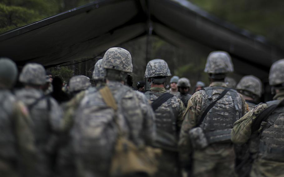 New Jersey Army National Guard Soldiers from Charlie Company, 1st Battalion, 114th Infantry (Air Assault) listen to a briefing before a day of live-fire battle drills on Joint Base McGuire-Dix-Lakehurst, N.J., April 9, 2018.