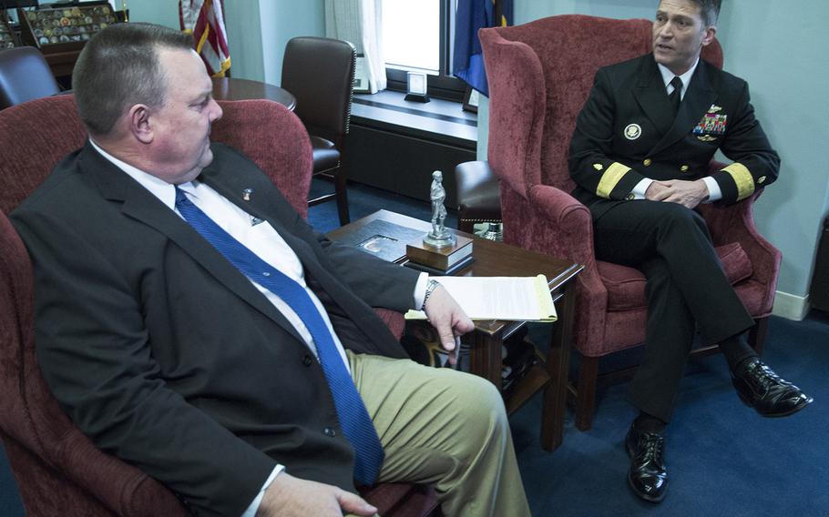 Rear Adm. Ronny Jackson, President Donald Trump's nominee to succeed David Shulkin as Secretary of Veterans Affairs, talks with Senate Veterans' Affairs Committee Ranking Member Jon Tester, D-Mont., in Tester's Capitol Hill office, April 17, 2018.