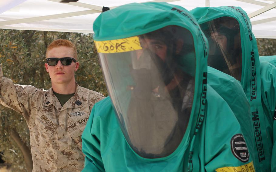 Petty Officer 3rd Class Corey Jernigan, a U.S. Navy hospital corpsman, looks on as U.S. Marines prepare take samples during a chemical, biological, radiological, nuclear training exercise, May 10, 2017, during Exercise Eager Lion at the Joint Training Center in Jordan.