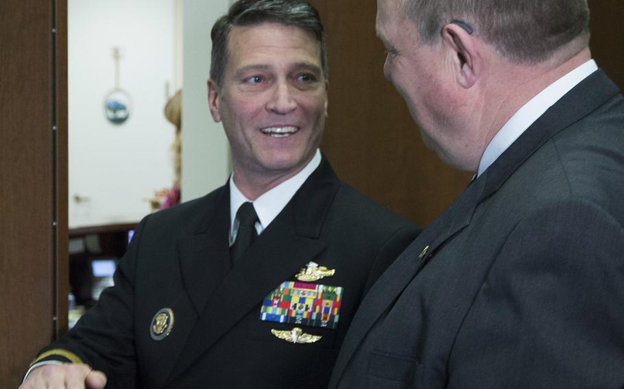 Rear Adm. Ronny Jackson talks with Sen. Jon Tester, D-Mont., in Tester's Capitol Hill office, April 17, 2018.