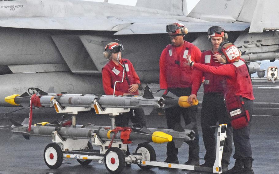 Crew members prepare to move ordnance for an FA-18 Super Hornet aboard the USS Harry S. Truman on May 8, 2018. The Truman is in the eastern Mediterranean launching air strikes against the Islamic State.