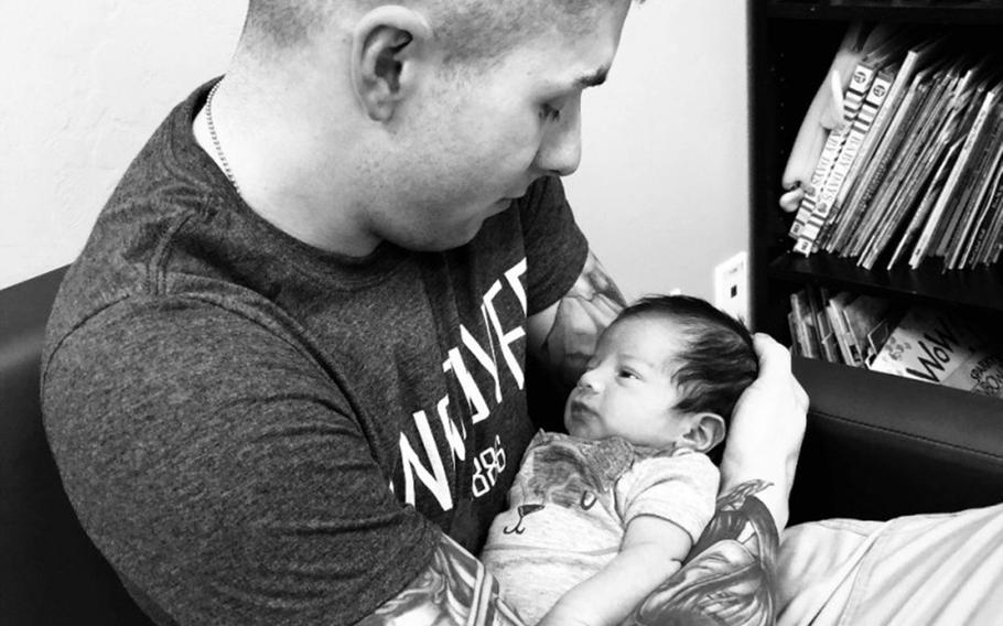 Sgt. Steven Garcia holds the baby, who is at the center of an unusual custody battle.