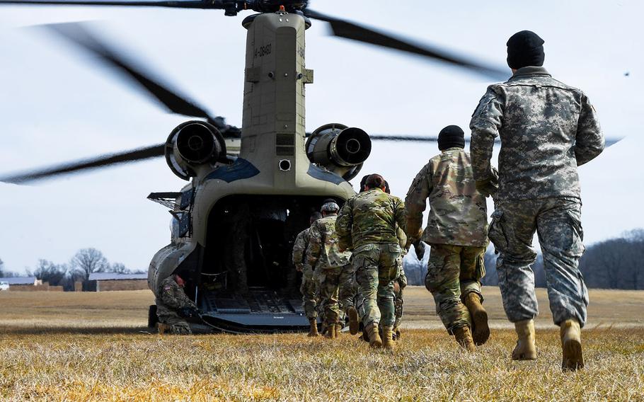 In a February 13, 2017 file photo, soldiers with the 101st Combat Aviation Brigade, 101st Airborne Division (Air Assault) load equipment into a CH-47 Chinook helicopter in preparation to jump their tactical operations center to a new location during Warfighter, a two-week command and control exercise at Ft. Campbell, Ky.