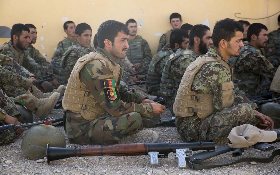 Soldiers with the Afghan National Army's 215th Corps listen to instructors in an offensive and defensive tactics course at Camp Shorabak in Helmand province on Sunday, June 3, 2018.