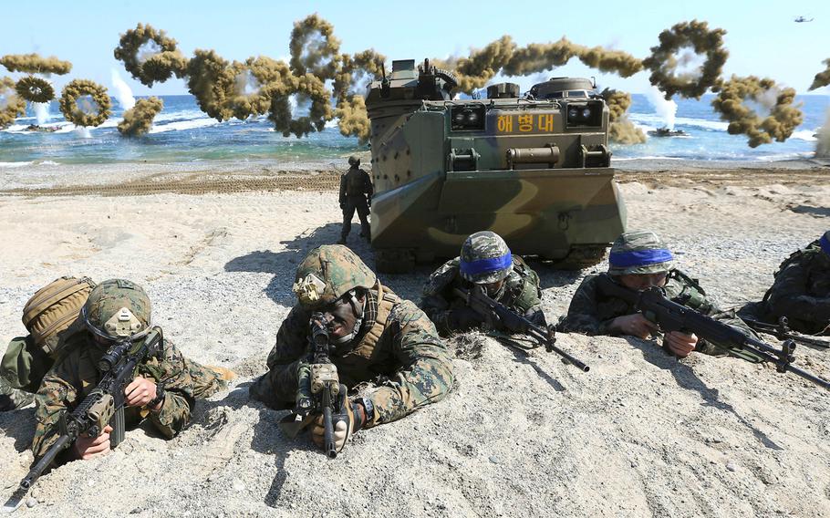 U.S. and South Korean servicemembers take positions after landing on a beach during a joint military combined amphibious exercise, called Ssangyong, part of the Key Resolve and Foal Eagle military exercises, in Pohang, South Korea, on March 12, 2018. 