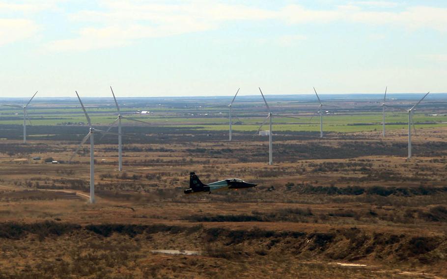 A T-38 Talon from Sheppard Air Force Base, Texas, maneuvers around a wind farm in this undated photo.