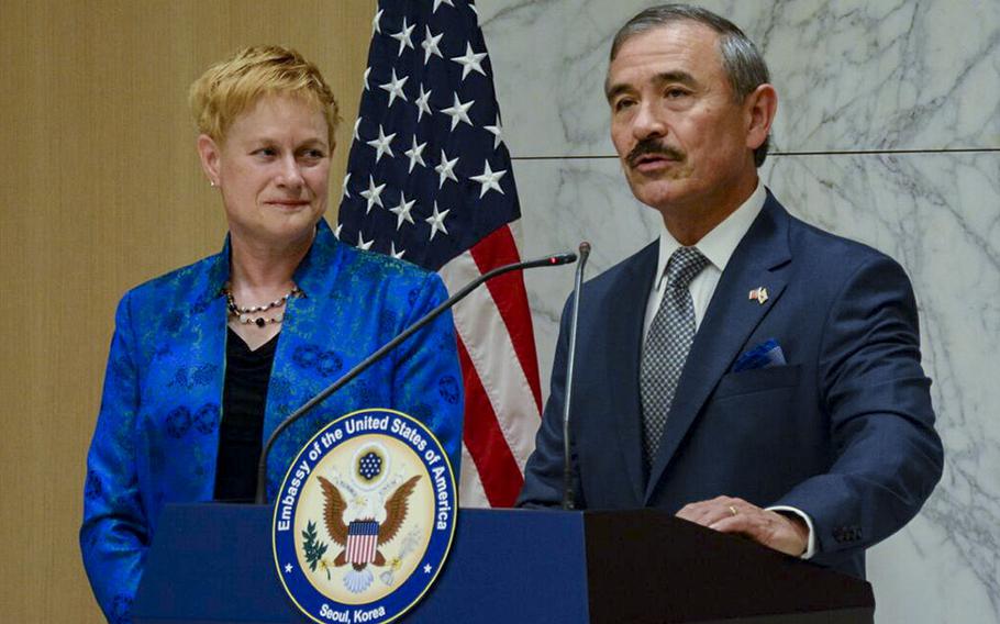 Retired Adm. Harry Harris sports a mustache while speaking to reporters alongside his wife, Bruni Bradley, at Incheon International Airport after arriving Saturday to start his new job as U.S. ambassador to South Korea.