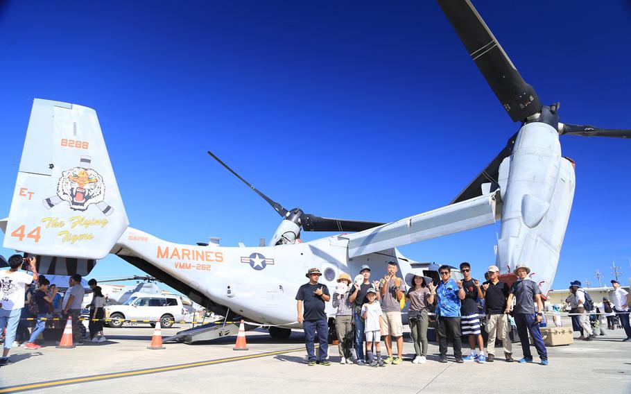 Japanese fans pose with an MV-22 Osprey tilt-rotor aircraft on Marine Corps Air Station Futenma July 8, 2018. 