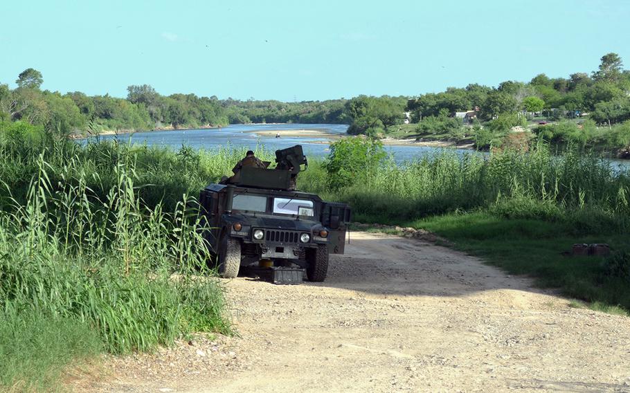 National Guard soldiers man an observation post in a Humvee under the Roma–Ciudad Miguel Alemán International Bridge in Roma, Texas on June 27, 2018.