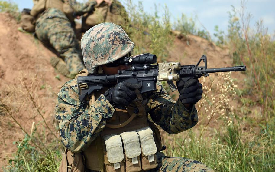 A U.S. Marine provides security for machinegunners while training with Ukrainian marines during Exercise Sea Breeze, Thursday, July 12, 2018.