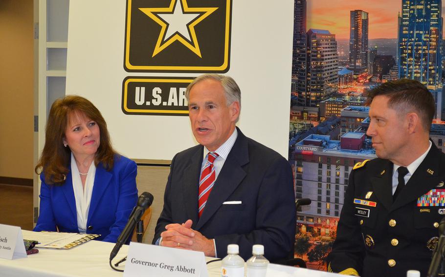 Texas Gov. Greg Abbott, center, speaks Friday during a news conference at the Greater Austin Chamber of Commerce to celebrate Austin as the home of Army Futures Command headquarters. On his right sits Charisse Bodisch, the chamber’s senior vice president of economic development, and to his left sits Lt. Gen. Eric Wesley, integration management officer for the Army Futures Command.
