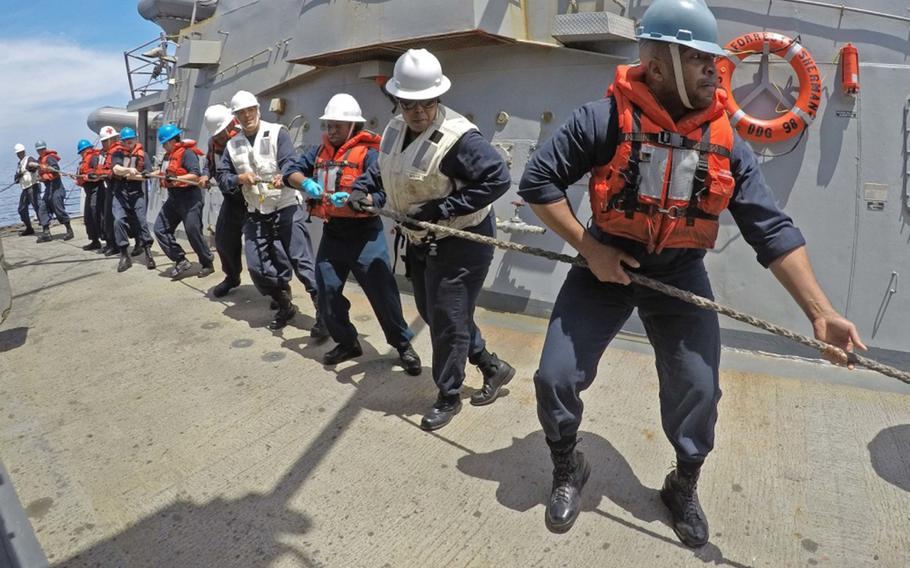 Sailors heave around a line aboard the guided-missile destroyer USS Forrest Sherman on May 16, 2018, during its deployment as part of the Harry S. Truman Carrier Strike Group.