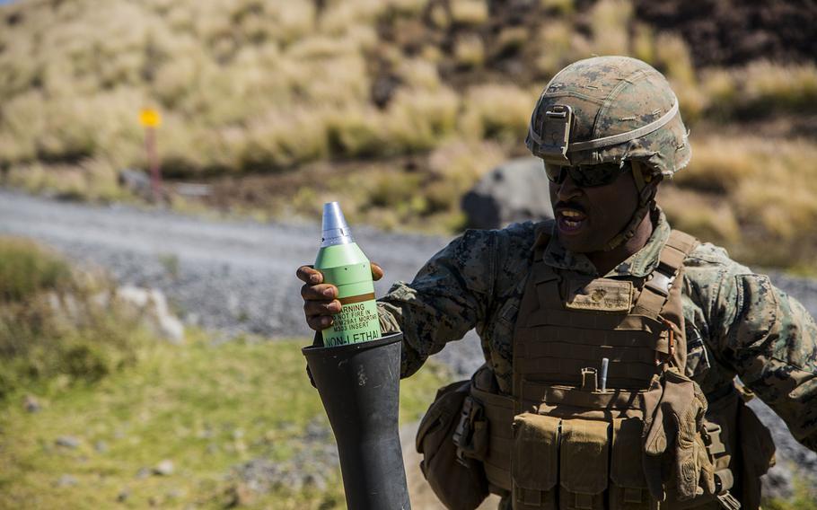 Lance Cpl. William Henderson, a mortarman with Weapons Company, 1st Battalion, 3rd Marine Regiment, fires an 81mm experimental non-lethal indirect fire munition round during a weapons testing event, July 16, 2018 at Pohakuloa Training Area, Hawaii.