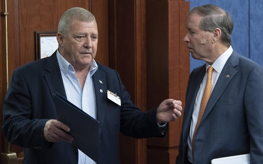 Marine Corps veteran Jerry Ensminger of White Lake, N.C., left, talks with Sen. Tom Udall, D-N.M., before a Capitol Hill press conference on August 1, 2018. Ensminger's daughter was exposed to toxic chemicals while the family was living at Camp Lejeune, N.C., and died of leukemia.