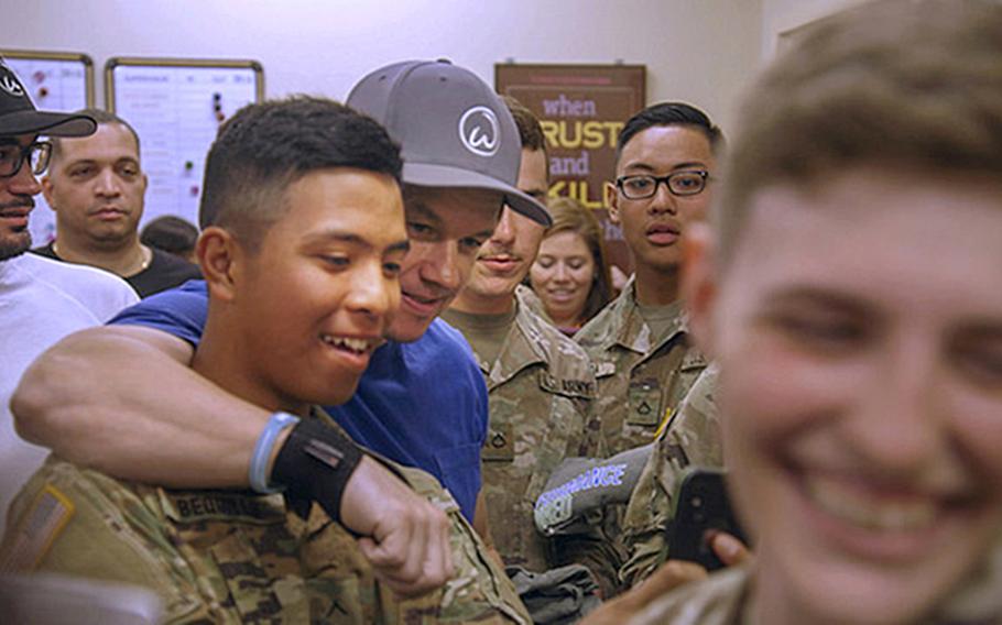 Through an agreement with the Army and Air Force Exchange Service, Wahlburgers will open its first location on a military installation in the spring of 2020 at Joint Base Lewis-McChord. In this photo, Mark Wahlberg meets with troops at the Fort Benning Exchange in May to thank them for their service. 
                