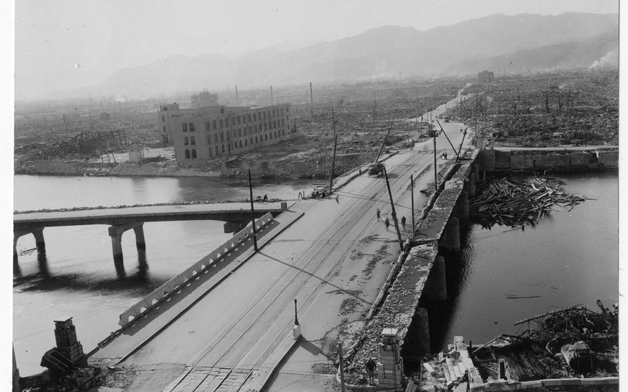 Aioi Bridge, which was a target for the atomic bomb dropped on Hiroshima on August 6, 1945, is shown damaged after the bombing. The bridge was about 250 meters from the center of the explosion. This photograph was among 36 photographs donated to the Hiroshima Peace Museum by Gayle Yoshikawa.