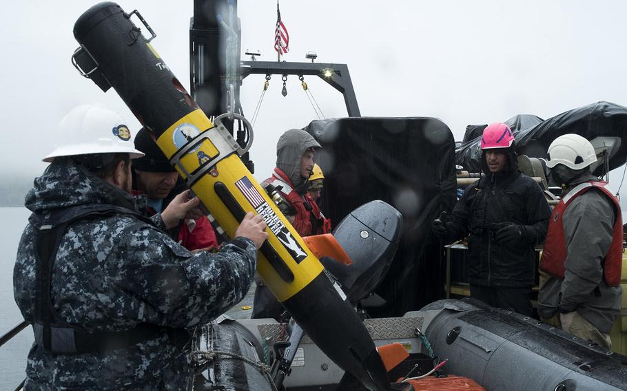 Project Recover team members Bob Hess and Eric Terrill prepare to launch one of four underwater vehicles used to scan the seafloor near Kiska, part of the Aleutian Islands of Alaska. On July 17, researchers discovered the missing stern of the USS Abner Read, a destroyer that was blown apart during World War II.