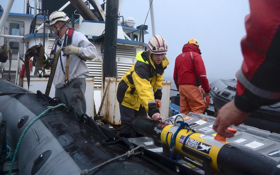 Eric Gallimore, a doctoral candidate at Scripps Institution of Oceanography at UC San Diego, secures "Maggie," an underwater vehicle used to help locate the missing stern of the USS Abner Read on July 17. The stern sank Aug. 18, 1943 at the height of World War II after being blown off by a Japanese mine.