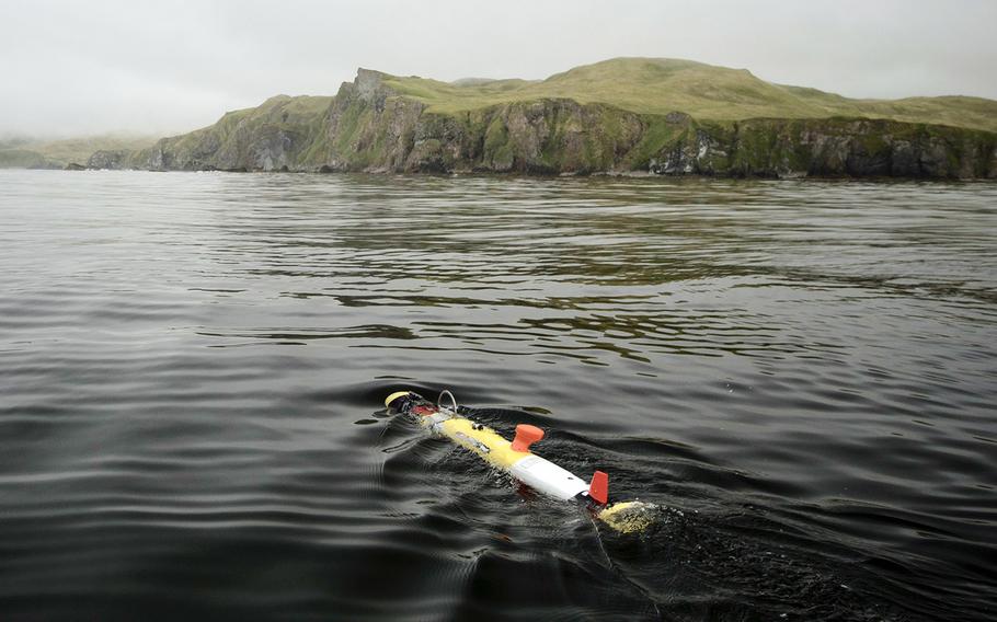 An underwater vehicle glides away from a research boat before diving beneath the surface, where it spent the next six hours systematically scanning the seafloor near Kiska, an island in Alaska. Underwater vehicles were used to help locate the missing stern of the USS Abner Read on July 17.