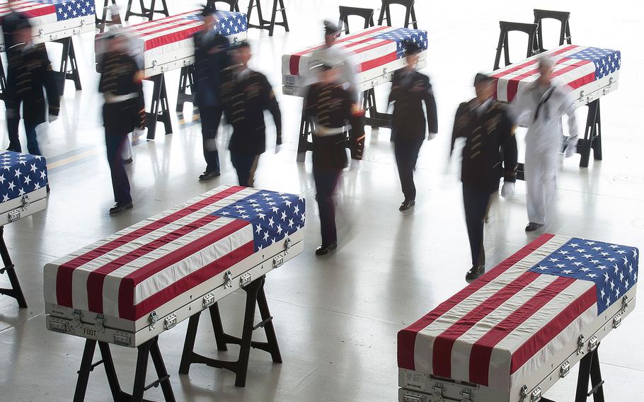 An honor guard detail of U.S. Indo-Pacific Command (INDOPACOM) personnel conducts an honorable carry ceremony at Joint Base Pearl Harbor-Hickam (JBPH-H), Hawaii, Aug. 1, 2018. The 55 flag-draped transfer cases contain what are believed to be the remains of American servicemembers killed in the Korean War.