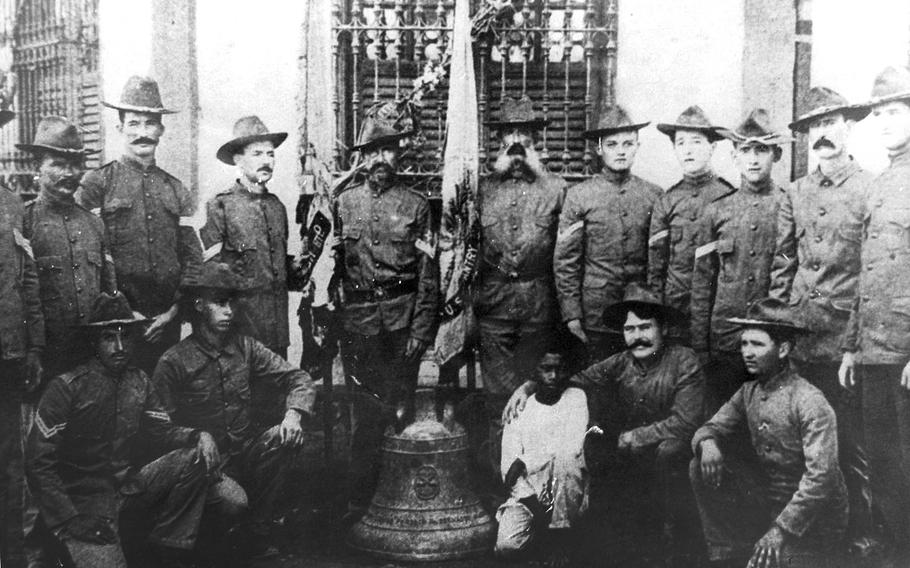 Soldiers from the 9th Infantry Regiment pose with one of three Balangiga bells in the Philippines in 1902 in this photo, displayed in the 2nd Infantry Division museum. Legislators from Wyoming oppose the Pentagon's planned return of the bells to the Philippines.