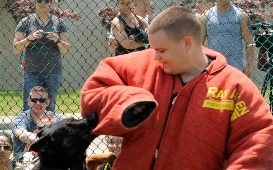 Robert Kelgard takes part in a military working dog demonstration during a sports day event for the children of a South Korean orphanage at Kunsan Air Base in 2013. The former U.S. senior airman has been jailed for sexually abusing orphans and possessing child pornography in a 2016 case that prompted new community guidelines at the base.