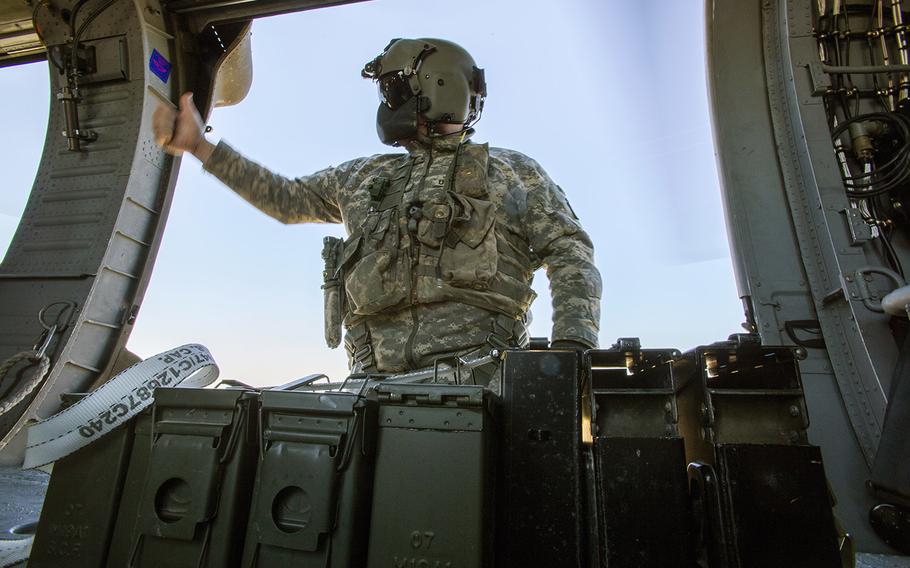 Staff Sgt. Paul Cimino, right, a master gunner with the 1-150th Assault Helicopter Battalion, New Jersey Army National Guard, gives the thumbs-up after securing M240B machine gun ammunition during an aerial gunnery training mission at the 177th Fighter Wing's Detachment 1, Warren Grove Gunnery Range, N.J., April 15, 2016.