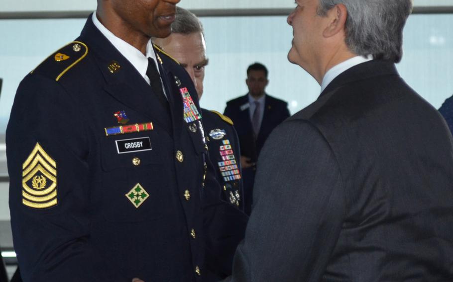Command Sgt. Maj. Michael Crosby, the top noncommissioned officer of the Army Futures Command, shakes hands with Austin Mayor Steve Adler following the Army Futures Command activation ceremony in Austin, Texas, on Friday.