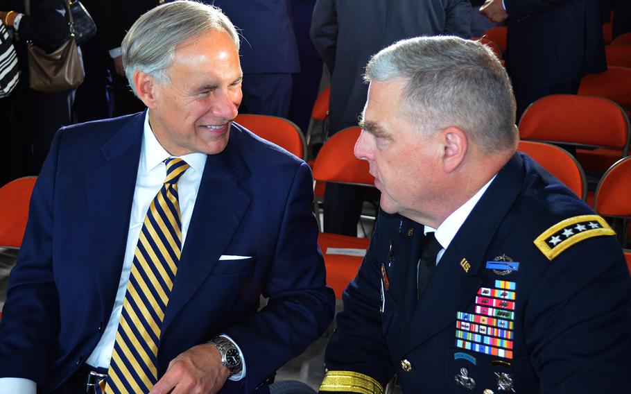 Texas Gov. Greg Abbott and Army Chief of Staff Gen. Mark Milley talk following the Army Futures Command activation ceremony in Austin, Texas, on Friday.