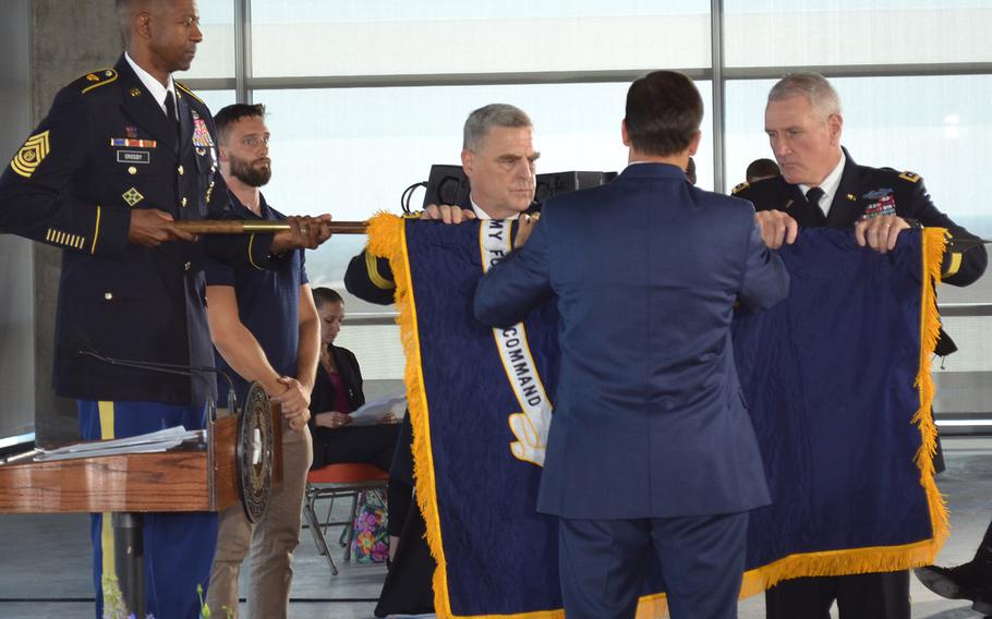 Command Sgt. Maj. Michael Crosby holds the flagpole of the newly activated Army Futures Command's flag while Gen. Mark Milley, Gen. John "Mike" Murray and Mark Esper unroll it during the Army Futures Command activation ceremony in Austin, Texas, on Friday. 