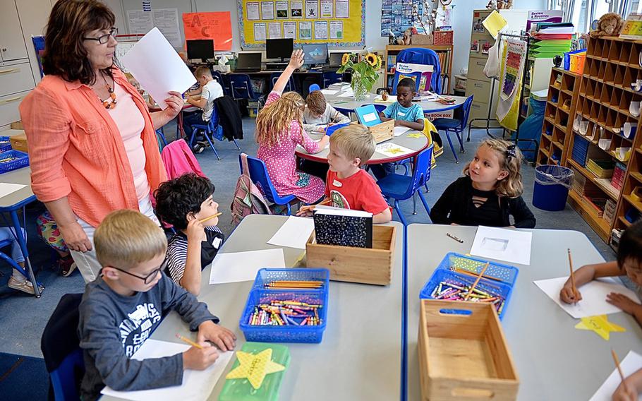 German immersion teacher Gabriele Arseneault talks to Landstuhl Elementary/Middle School students about a book her class read together on the first day of school.
                