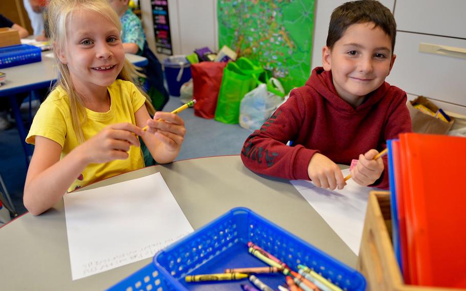 Mary Kate Feldt and Rylan Gonzalez, both 7, sit next to each other in a German immersion class at Landstuhl Elementary/Middle School, Germany, Monday, Aug. 27, 2018.
                