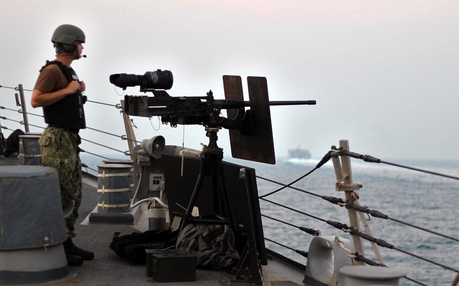 Petty Officer 3rd Class Calvin Day stands watch as the guided-missile destroyer USS The Sullivans conducts a routine transit through the Strait of Hormuz, Aug. 5, 2018.