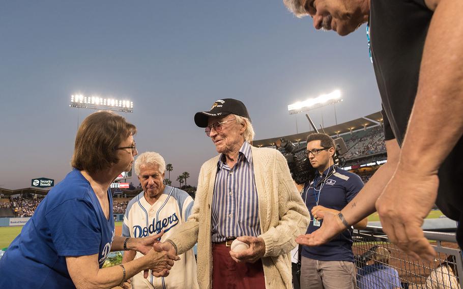 Fans shake hands with Sam Folsom at Dodger Stadium in Los Angeles on Aug. 14, 2018 after the 98-year-old World War II Marine Corps veteran was honored by the team.