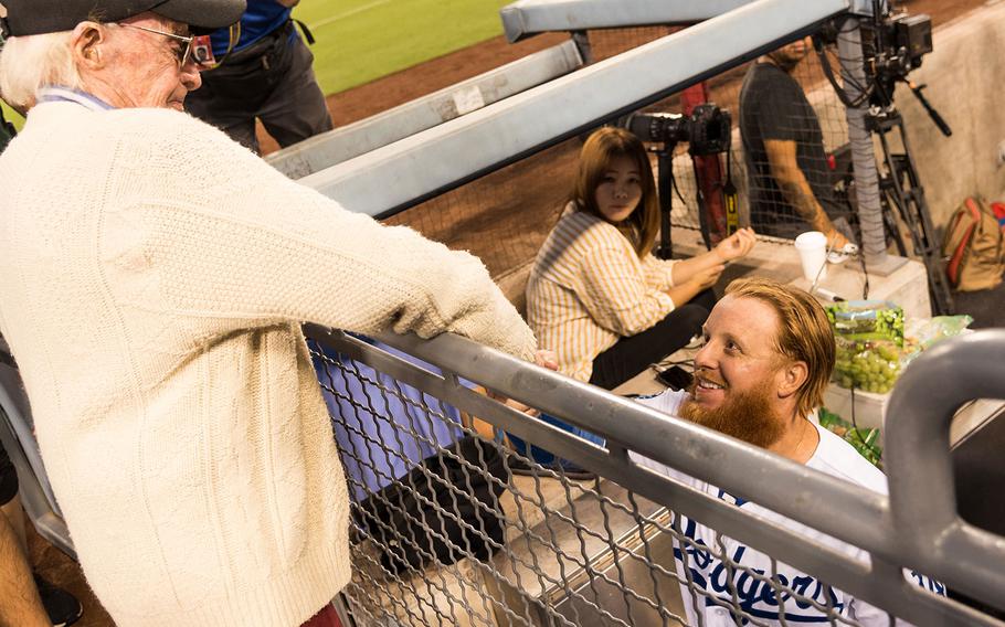 Los Angeles Dodgers star third baseman Justin Turner shakes hands with 98-year-old Marine veteran Sam Folsom in the middle of the second inning during a game against the San Francisco Giants on Aug. 14, 2018. 