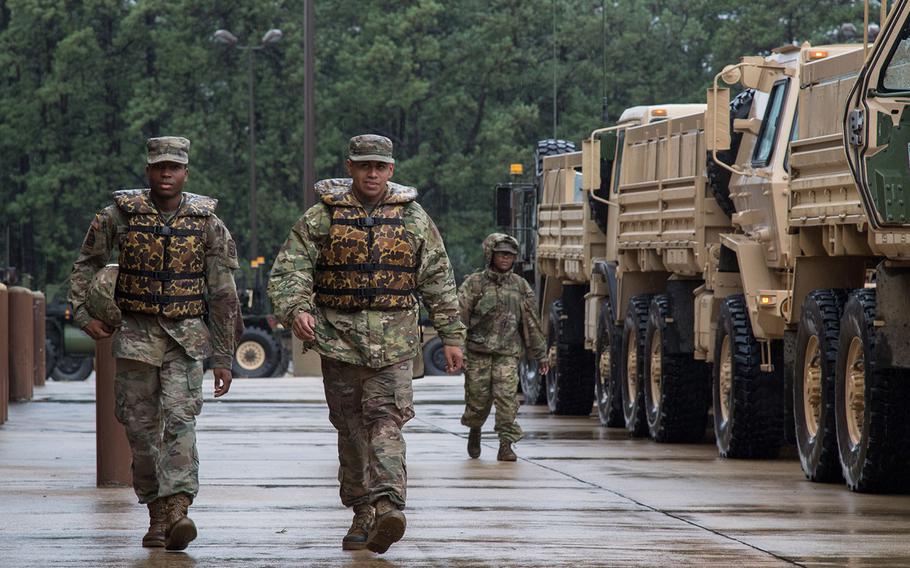 U.S. Army Pfc. Attlee Simmons (left) and Cpl. Ernesto Pacheco, both assigned to the 249th Composite Supply Company, 189th Combat Sustainment Support Battalion, 82nd Sustainment Brigade, 82nd Airborne Division, prepare to head out from Fort Bragg and provide aid to the surrounding areas of North Carolina that have been flooded by Hurricane Florence, Sept. 15, 2018.