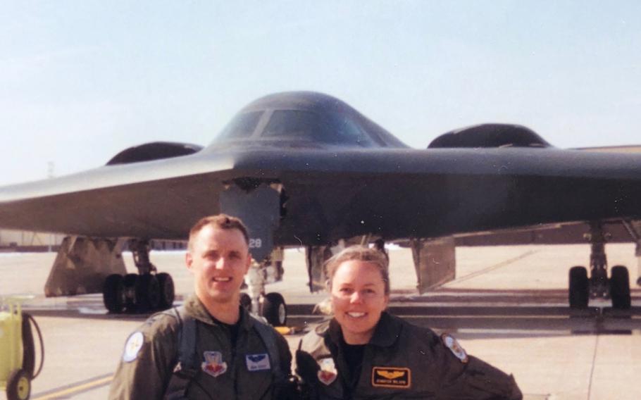 Then-Capts. John and Jennifer Avery smile for a photo in front of the B-2 Spirit at Whiteman Air Force Base, Mo.