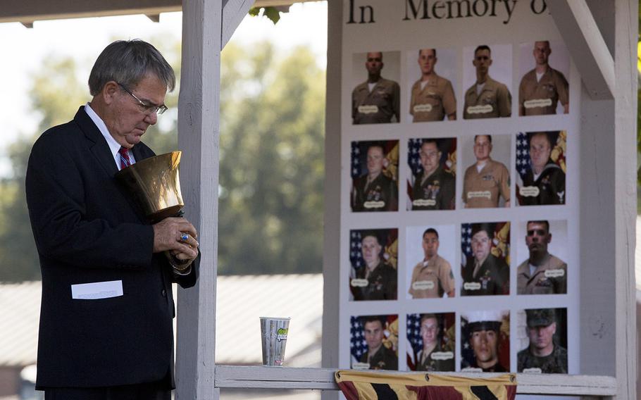 In an October, 2017 file photo, Doug Russell of Moorhead, Miss., rings a bell during a final roll call of the 15 Marines and one sailor who died in a C-130 plane crash in Moorhead in July 2017.