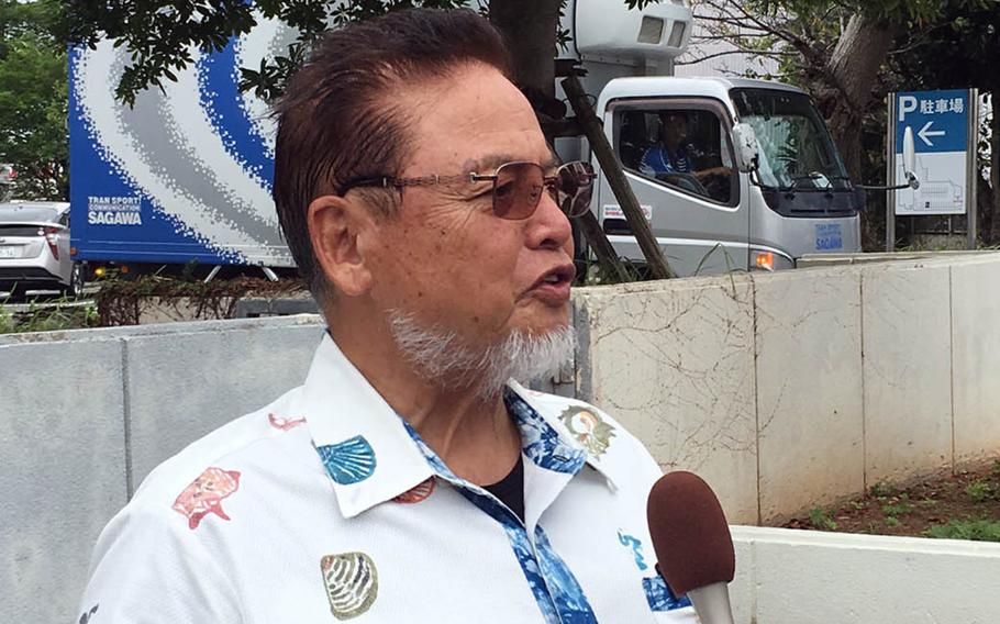 Kenei Yamashiro, a leader of a group seeking $10 million in damages over noise from Marine Corps Air Station Futenma, speaks to reporters near Naha District Court, Friday, Sept. 28, 2018.