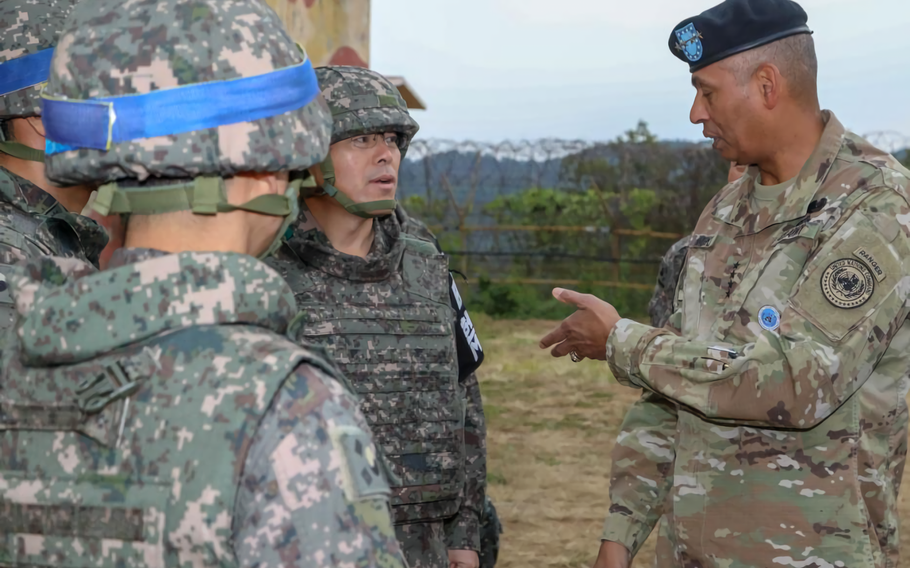 U.S. Army Gen. Vincent K. Brooks, Commander of United Nations Command, discusses the current land mine removal efforts ongoing at Arrowhead Hill in the Demilitarized Zone with Republic of Korea Army personnel.