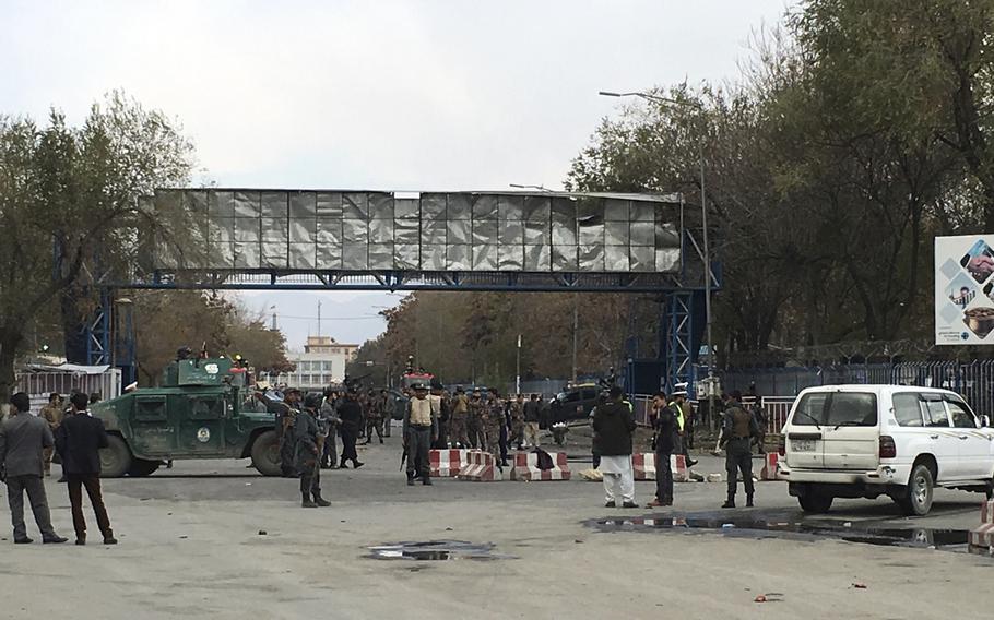Security forces inspect the site of a suicide attack in the capital of Kabul, Afghanistan, Monday, Nov. 12, 2018. Afghan officials confirm at least three people killed in a blast happened near a high school and the Kabul municipality office while hundreds of people gather to protest against Taliban attacks in Jaghuri and Malistan districts of eastern Ghazni province.