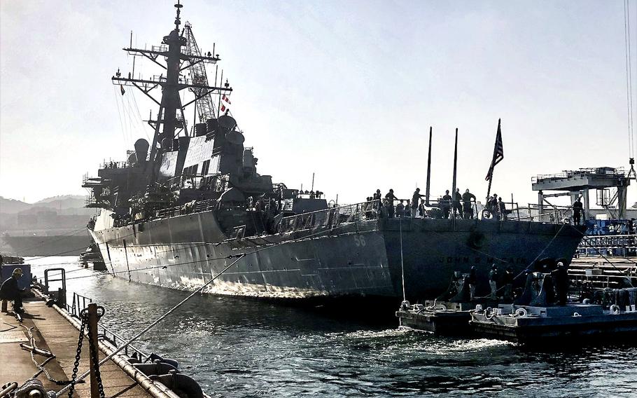 The USS John S. McCain floats for the first time in 11 months as its dry dock at Yokosuka Naval Base, Japan, is filled with water, Tuesday, Nov. 27, 2018.