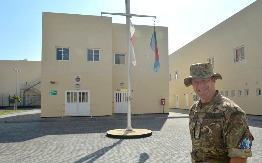 Lt. Guy Wadge, spokesman for U.K. Naval Support Facility Bahrain, poses in front of the installation's administration building.