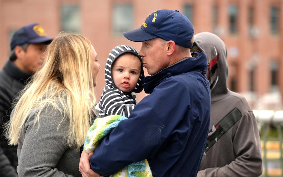 A Coast Guard Cutter Munro crew member embraces his son after the cutter returned home to Alameda, Calif., Dec. 24, 2018.