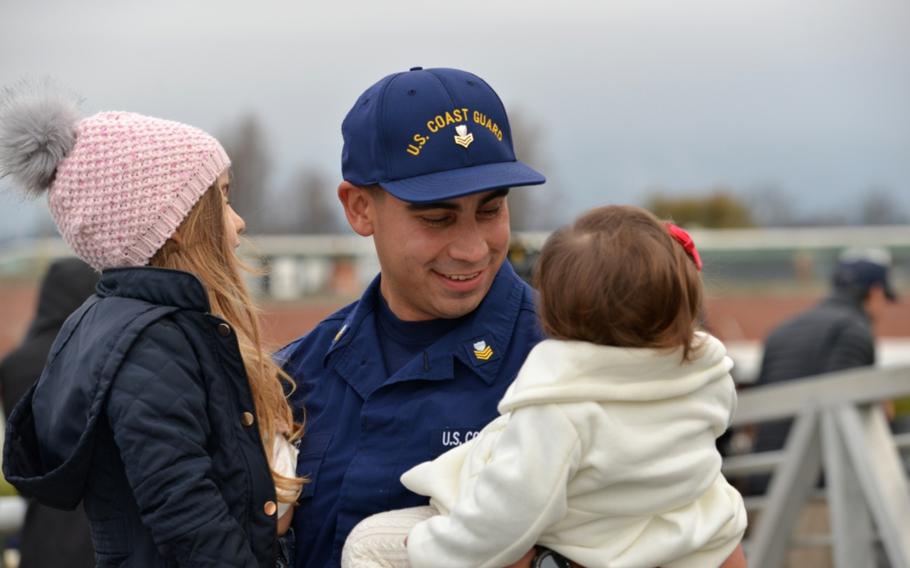 A Coast Guard Cutter Munro crewmember embraces his children after the cutter returned home to Alameda, Calif., Dec. 24, 2018.