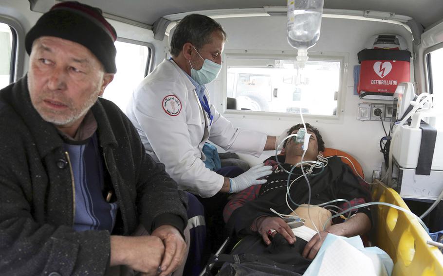 A man injured by an explosion is treated in an ambulance, in Kabul, Afghanistan, Thursday, March 7, 2019.