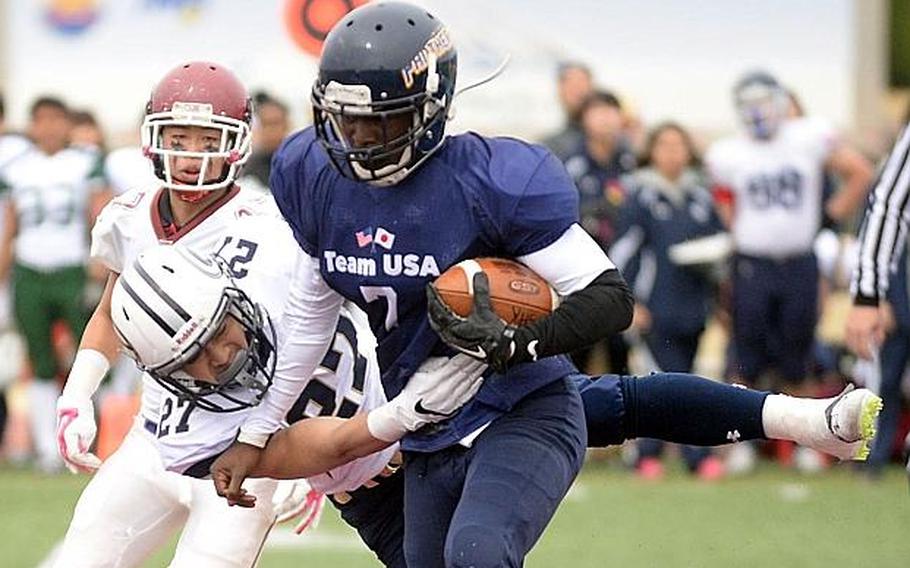 Sincere Powell of Guam High School is hemmed in by Riku Koyama of Gakushiun University during the Tomodachi Bowl at Reid Memorial Stadium, Naval Air Facility Atsugi, Japan, March 10, 2019.