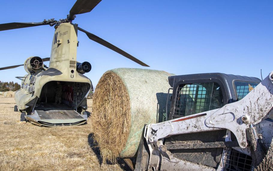 Nebraska Army National Guard Soldiers used a CH-47 Chinook helicopter to airdrop multiple bales of hay, March 20, 2019.