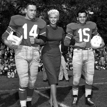Jayne Mansfield poses with two football players at the Frankfurt Football Stadium, Oct. 5, 1957. The actress was there to attend the game between Northern Area Command’s Black Knights and 10th Division Trains. 