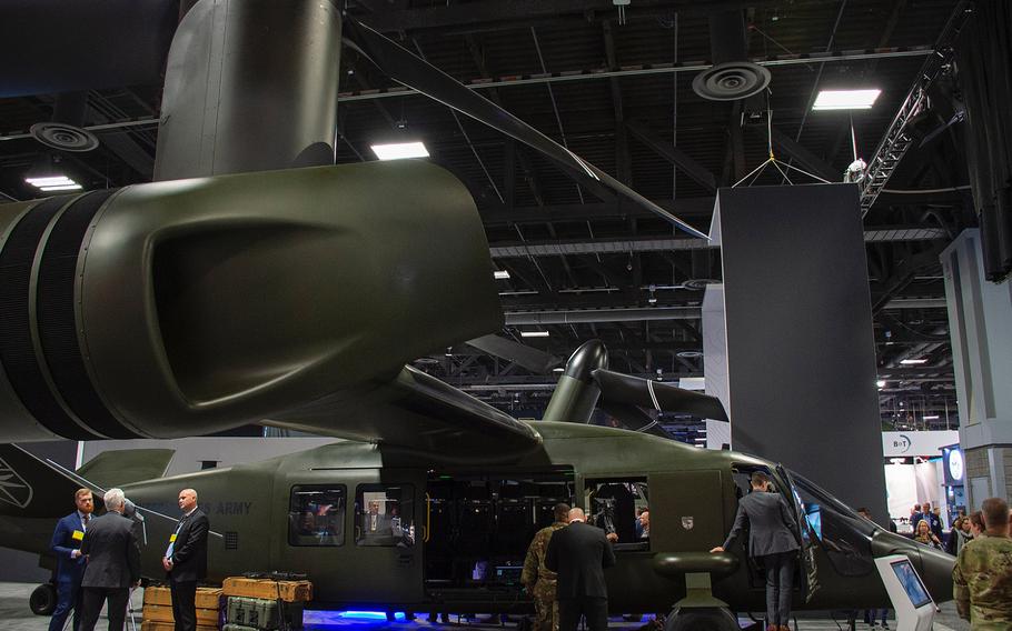 A steady flow of visitors look over the Bell V-280 Valor tilt rotor aircraft on display at the 2019 AUSA convention in Washington, D.C., on Tuesday, Oct. 15, 2019.